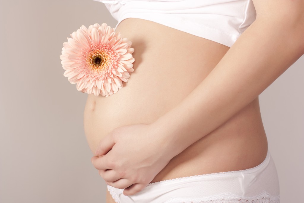 Pregnant woman with pink flower